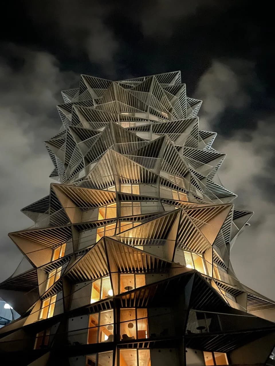 The folded steel tower on Grådybet at night, lit from within